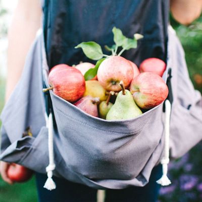 View full size image The Roo Gardening & Harvest Apron holding a bunch of apples