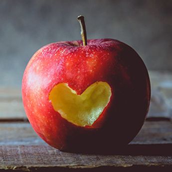 Apple with a heart-shaped bite out of it