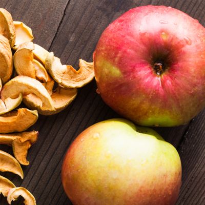 View full size image Large apples next to dried apples