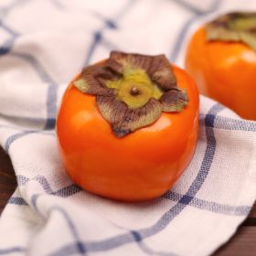 Persimmon on kitchen towel